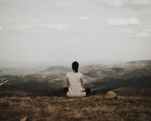 Woman in the hillside learning how to practice mindfulness through meditation, from a nonprofit in San Mateo County, California.