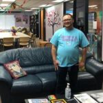 Pride Center director standing in front of couch, smiling.